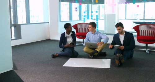 Business Colleagues Working Together on Floor in Office