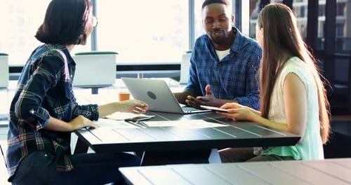 Colleagues Meeting at Table in Modern Workplace