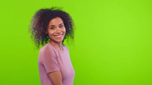 Cute Young African American Smiling Woman Turns and Flirts on Green Screen