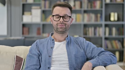 Adult Man Talking While Sitting on a Couch