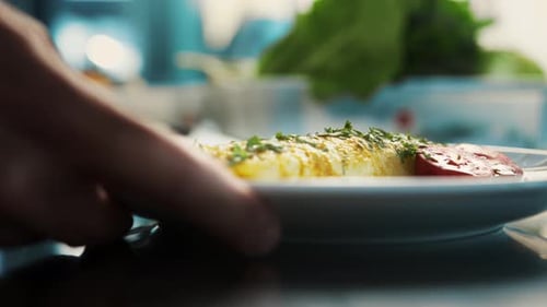 Professional restaurant kitchen, close-up: The chef serves an omelette