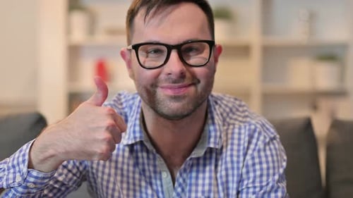 Close Up of Positive Young Man Showing Thumbs Up