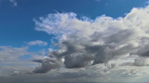 Dramatic Clouds Dancing in Blue Sky Aerial