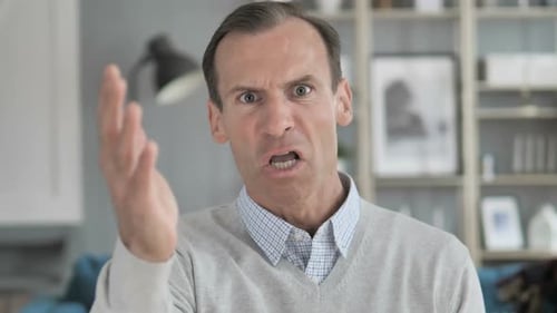 Adult Man Gesturing Angrily Indoors