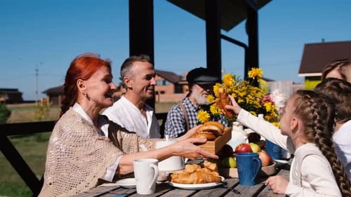 Family Dinner in the Garden on the Terrace on a Rustic Wooden Table the Concept of Eating Healthy