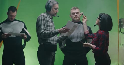 Film Crew Prepares Actor on Green Screen Set