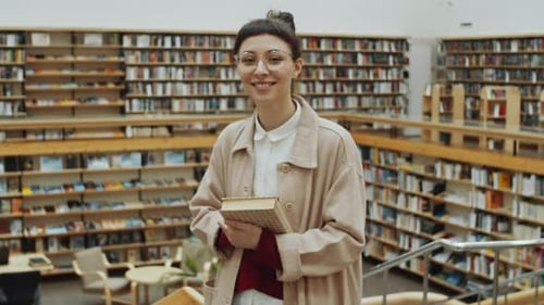 Portrait of Young Woman with Book in Library