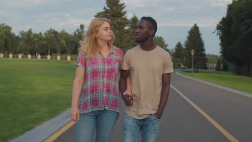 Multiethnic Couple in Love Taking a Walk in Park