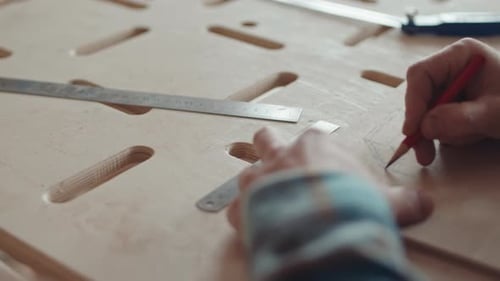 Carpenter Making Blueprint on Wooden Board