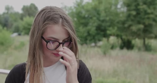 Woman in Glasses Smiling Outside
