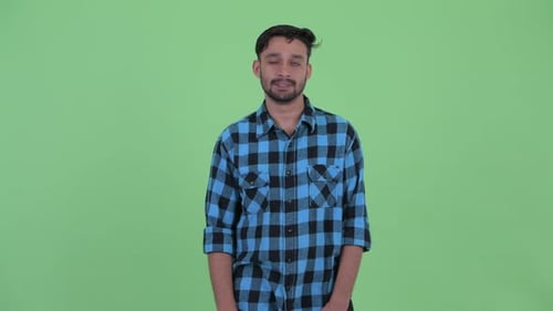 Young Adult Man Giving Thumbs Down on Green Screen