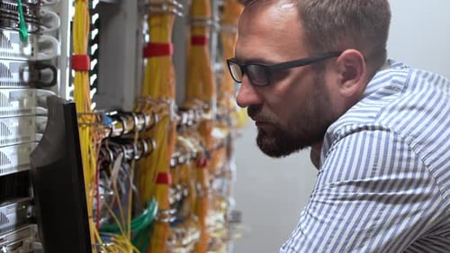 Technician Working in a Server Room