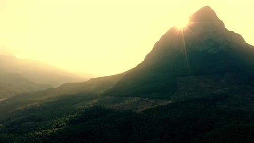 Yellow Morning Sun Shining Over Mountain Peak and Valley