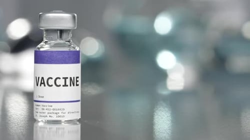 Vaccine Vial on Reflective Medical Surface