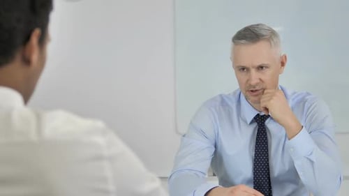Grey Hair Businessman Talking with Businessman in Office Discussing Work