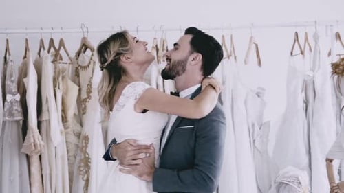 Happy Couple Embrace in Bridal Shop