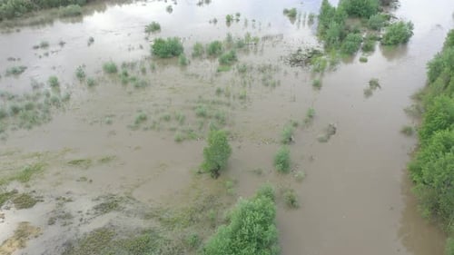 Overflow of water from river body from above 4K aerial video