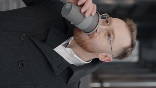Vertical Video of the Businessman Walking Near Office Center and Drinking Coffee