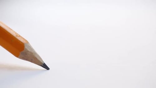 Yellow Pencil Tip Resting on White Surface