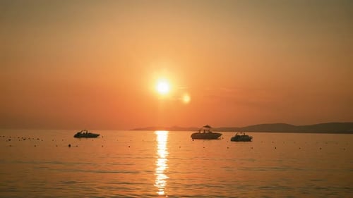 Silhouette of a Three Boats in the Sea at Sunset