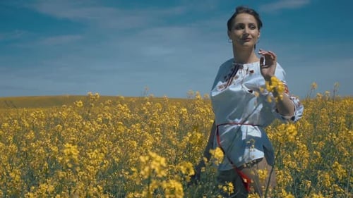 Ukrainian Woman in Ethnic Dress in the Field