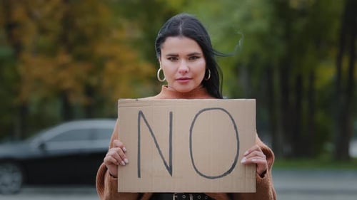 Woman Holding a 'No' Protest Sign Outdoors