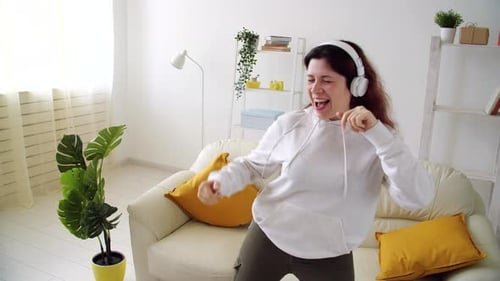 Woman Dancing and Enjoying Music at Home