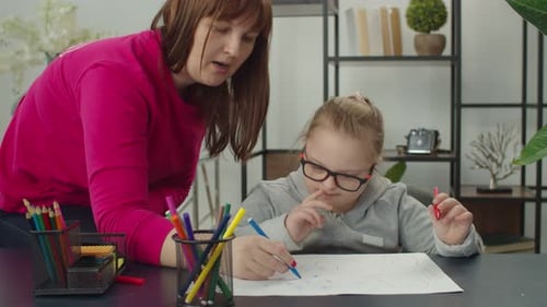 Child Drawing With Adult Guidance Indoors
