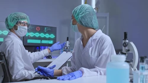 Scientists Working in the Laboratory With Microscopes