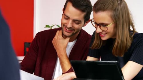 Colleagues Collaborating on Documents in Office