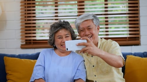 Happy Elderly Couple Taking Selfie with Mobile Phone