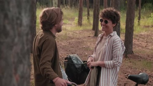 Couple Standing In Woods And Chatting