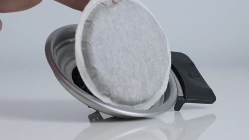Coffee Pod Being Placed into Coffee Maker Filter