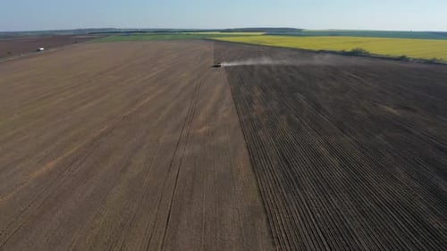 Tractor Cultivating Farmland Aerial View