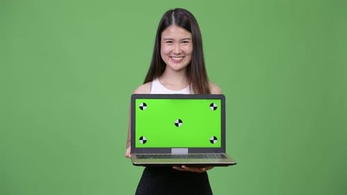 Young Woman Holding Laptop with Green Screen