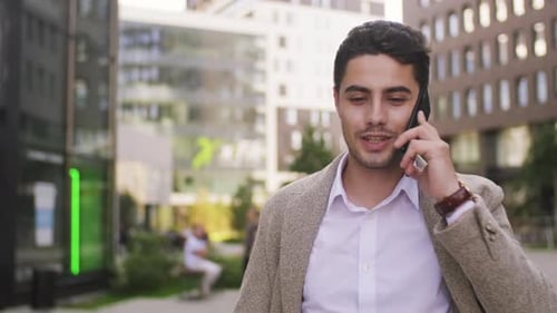 Young Adult Man Talking on Phone in City
