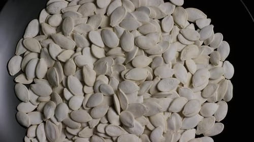 Pile of White Pumpkin Seeds on a Plate