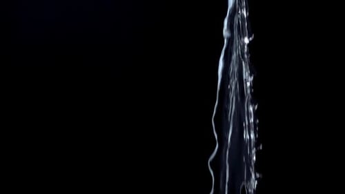 Pouring Stream of Reflective Water in Macro Shot