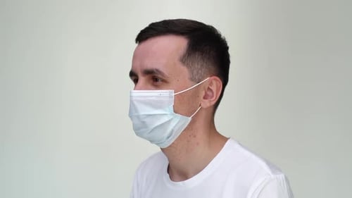 Young Adult Removing Medical Face Mask