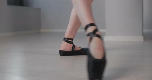 Dancer Performs Releve in Black Pointe Shoes