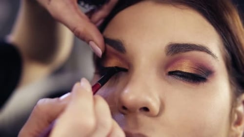 Finishing Up Thesmokey Eyes Make Up Look By Applying Black Liquid Eyeliner on the Upper Lashline