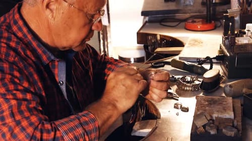 Jeweler Working on Ring at Workbench Close-Up