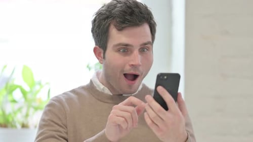 Man Smiling Looking at Mobile Phone Close Up