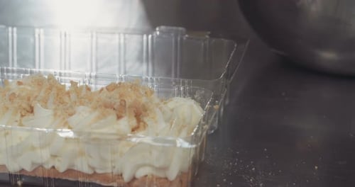 Slow motion - Baker using a pastry bag to make a cheese cake
