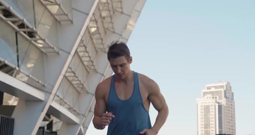 Front View of Handsome Sport Man Running Outdoors