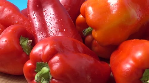 Fresh Red Bell Peppers on Wooden Surface