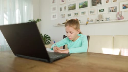 Girl Studying with Laptop in Sunny Home