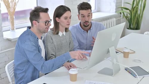 Creative Startup Team Working on Desktop in Modern Office