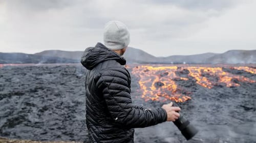 Photographer Looks at Active Lava Field in Iceland