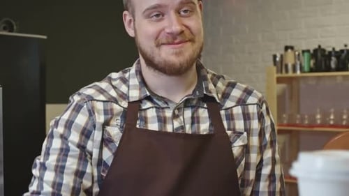 Friendly Barista Serving Coffee to Customer at Cafe